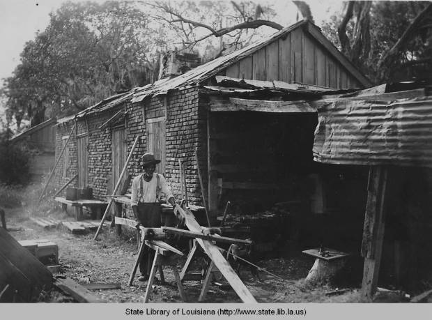 Man working outside old slave quarters, 1930s. Source: Louisiana Digital Library